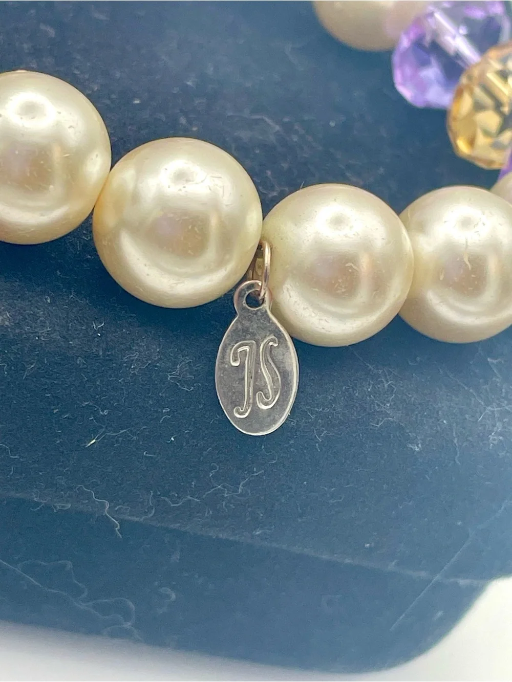 Jessica Simpson Pearl Stretch Bracelet with Purple Crystal Flower Charm. 8 inch